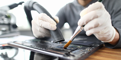 Give Your Computer Some TLC - person cleaning their computer