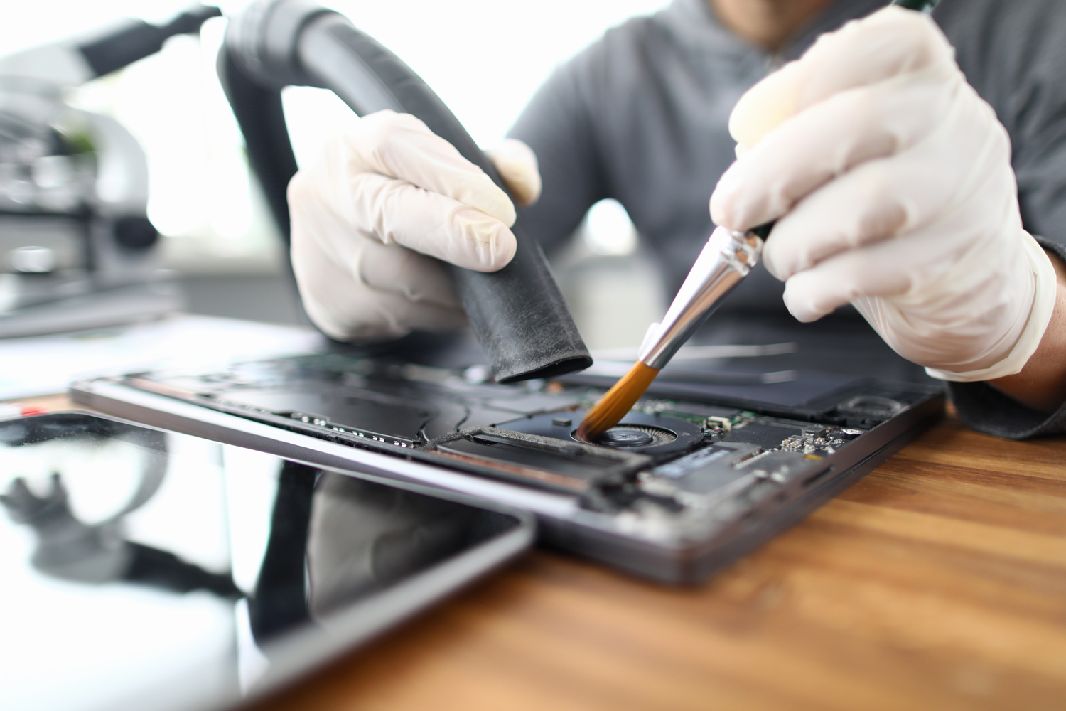 Give Your Computer Some TLC - person cleaning their computer